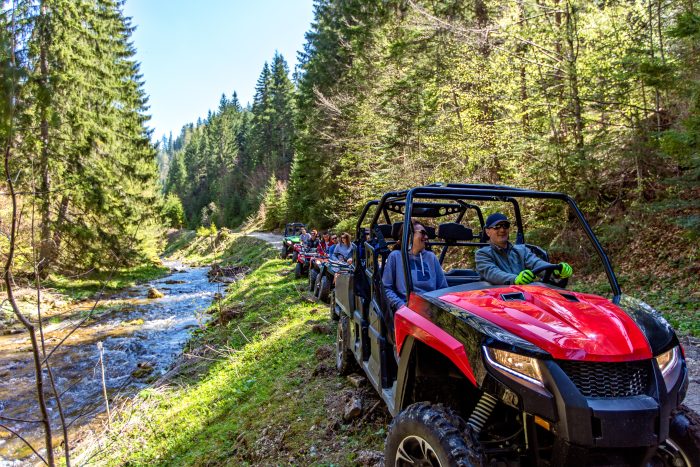 People driving ATVs on a trail in the woods in Wisconsin