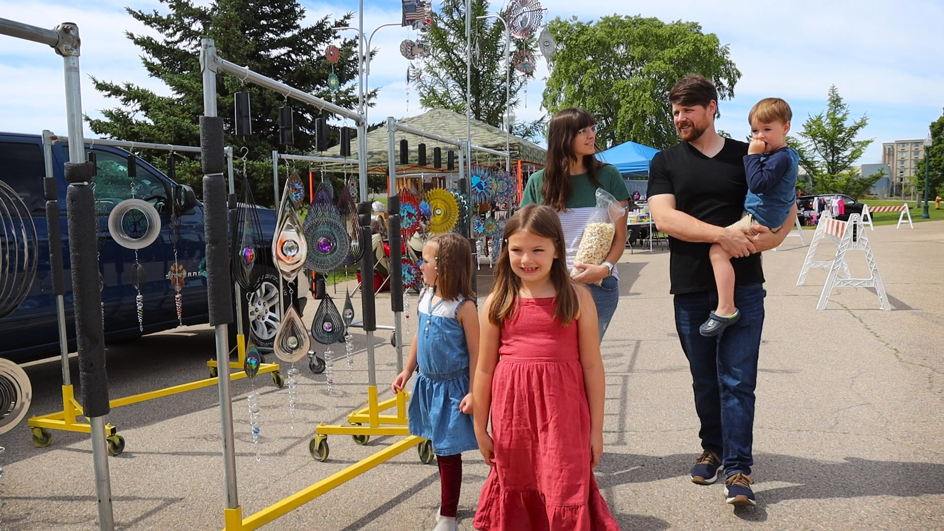 Family walking down the path at a farmers market