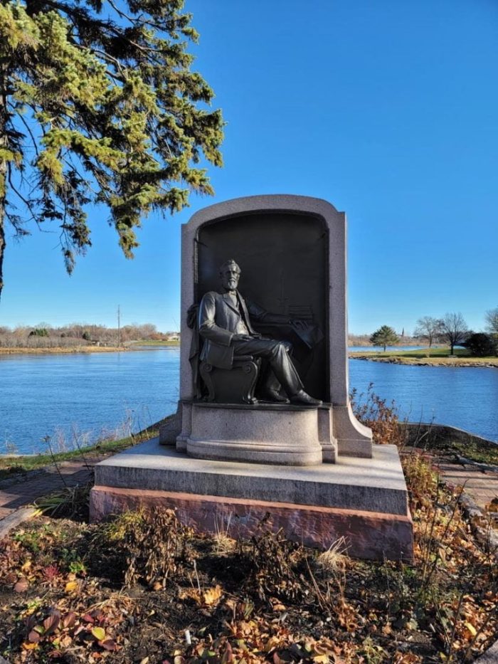 Memorial for Isaac Stephenson in front of the river in Marinette
