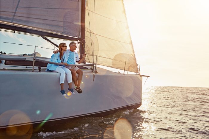 Couple sailing on a boat enjoying the sunset